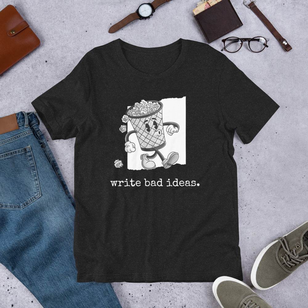 Unisex t-shirt, soft and lightweight, with a whimsical "write bad ideas" graphic, flat lay with accessories.