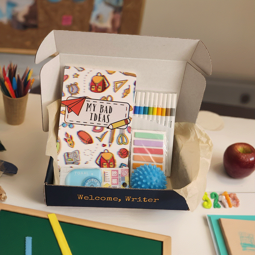 The Write Bad Ideas Subscription Box on a teachers desk, writing supplies are visible.