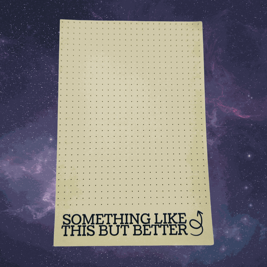 Sheet of grid paper with text 'Something Like This But Better' on a starry space background