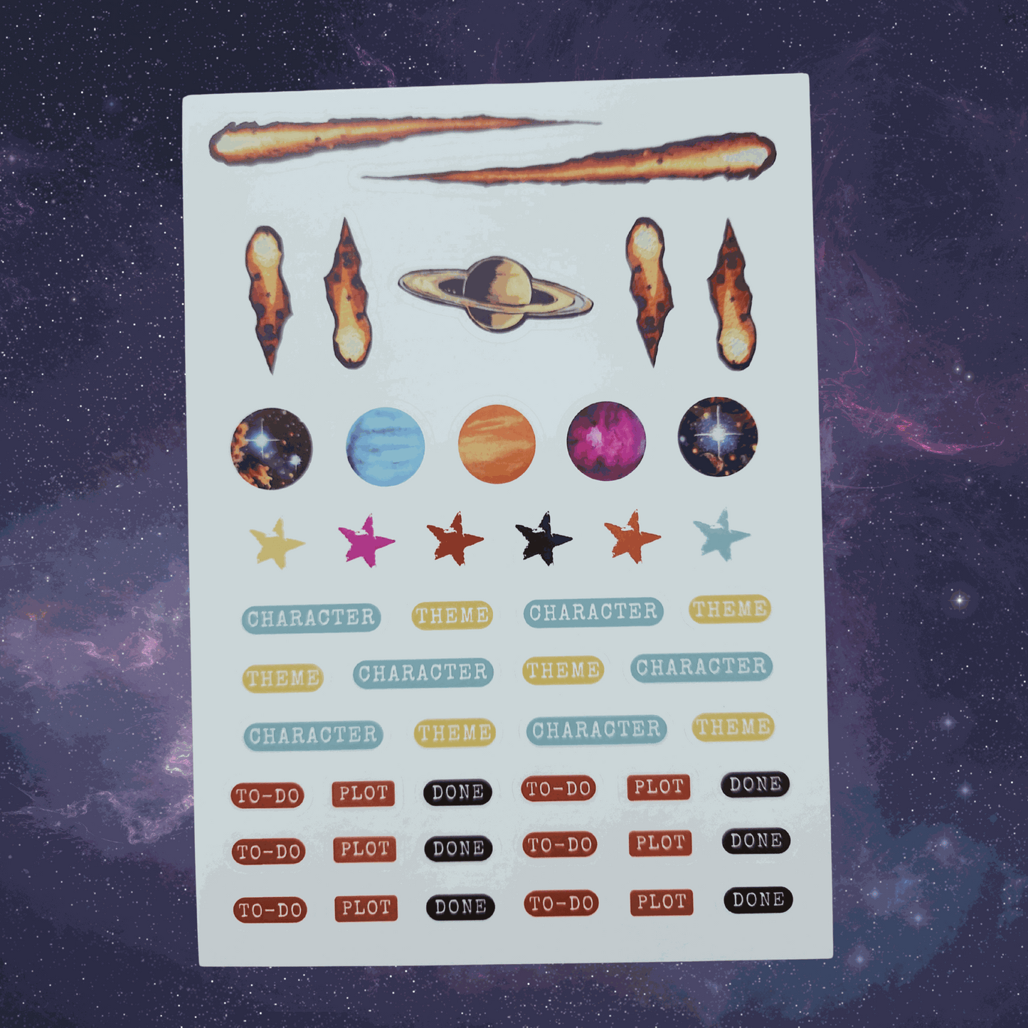 Sheet of stickers with space-themed designs on a starry background