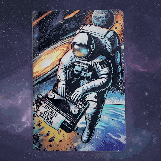 A5 Astronaut Typewriter notebook with astronaut on typewriter cover and dot grid pages